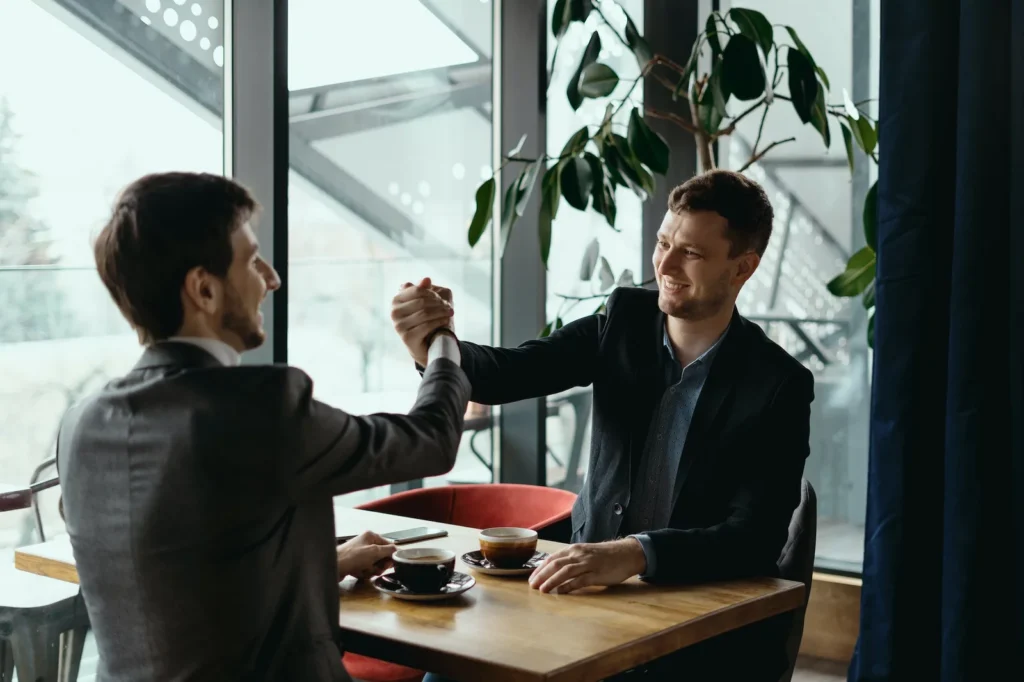 Two business men celebrating a deal